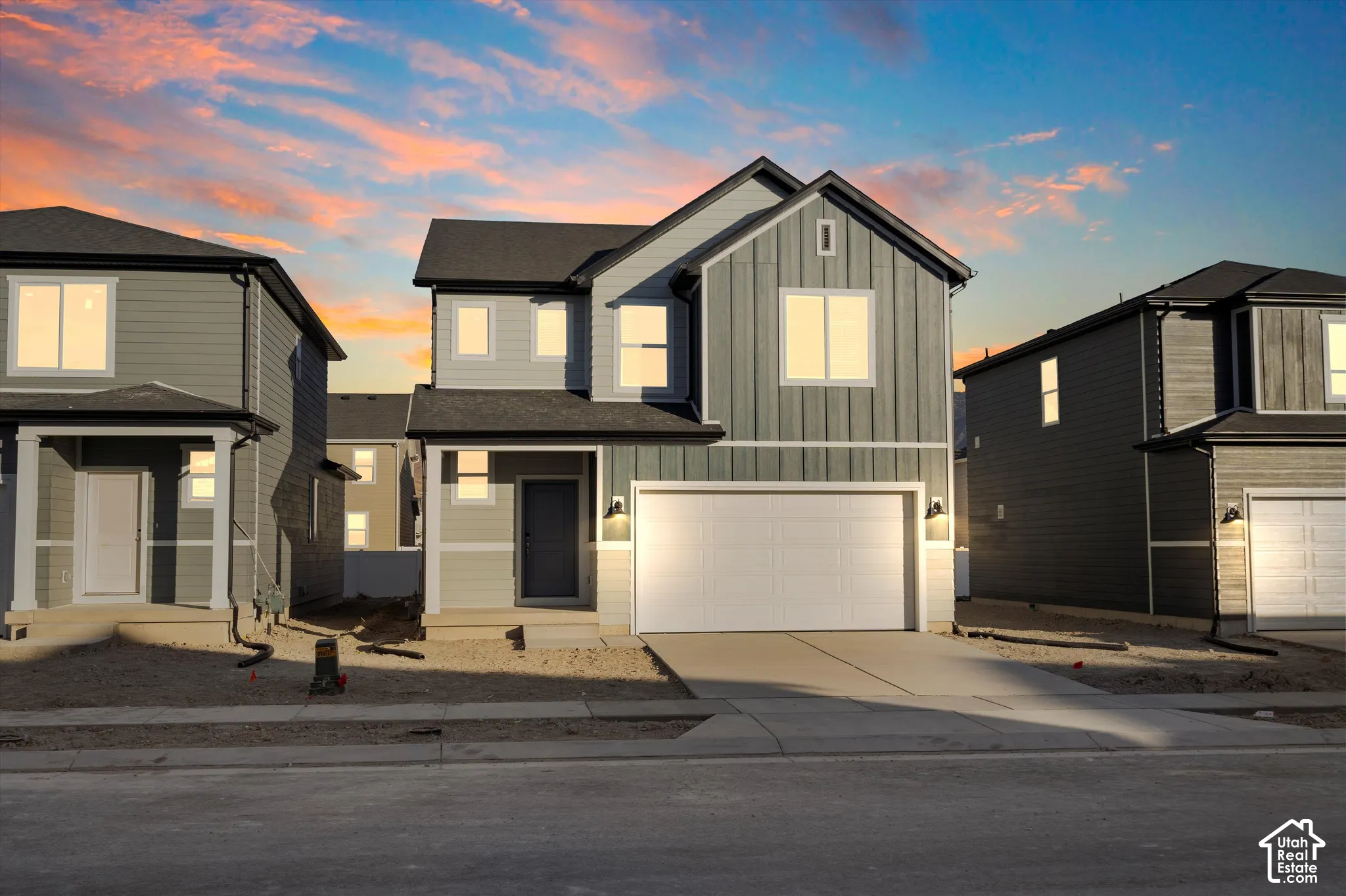 **DISCLAIMER** Elevation and exterior colors may vary.  Two-story exterior featuring a mix of horizontal lap siding and vertical board-and-batten siding, a covered entryway, and an attached two-car garage