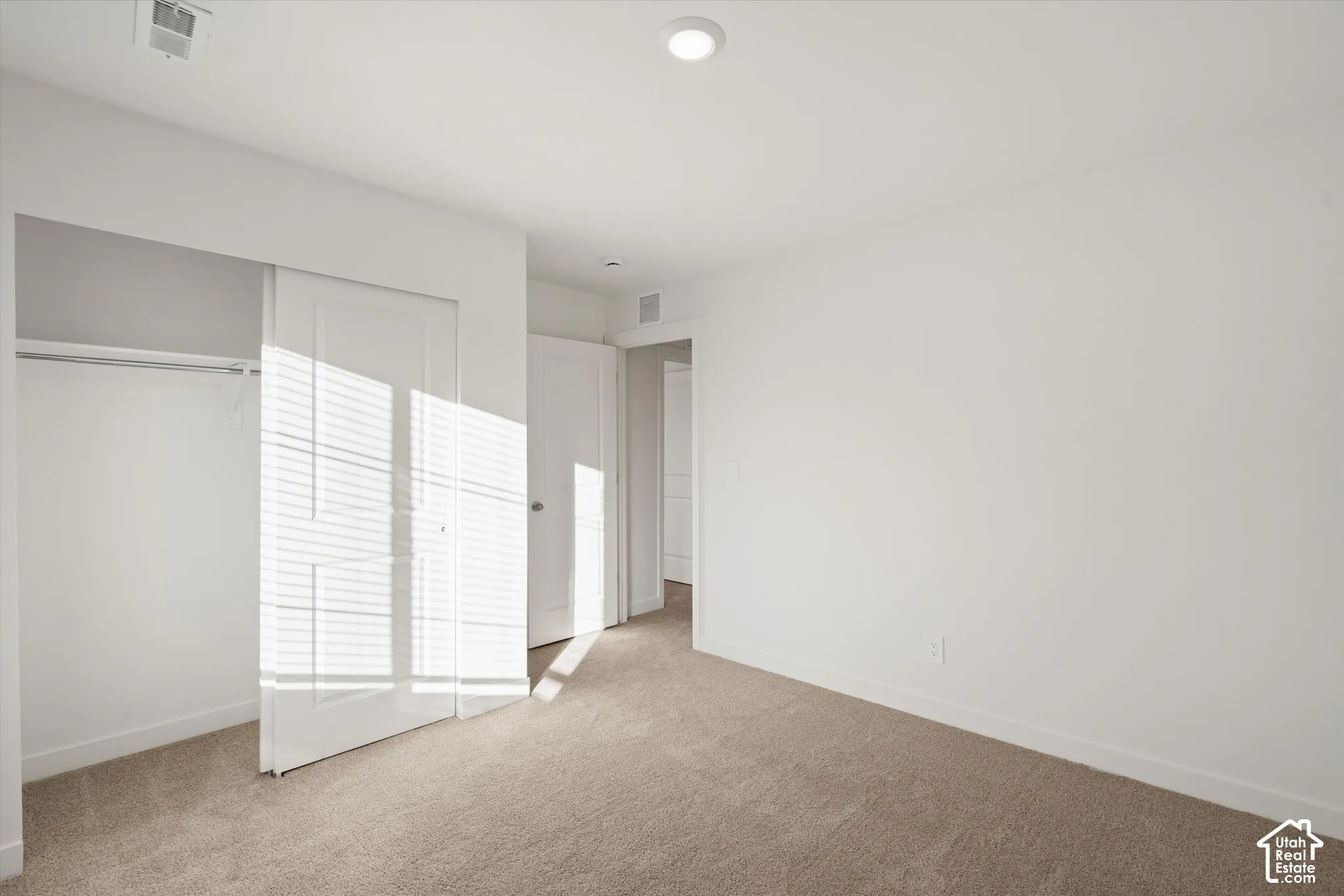 **Disclaimer** Interior package & colors may vary.  Neutral-toned carpeting, recessed ceiling lighting, and a closet with a two-panel sliding door