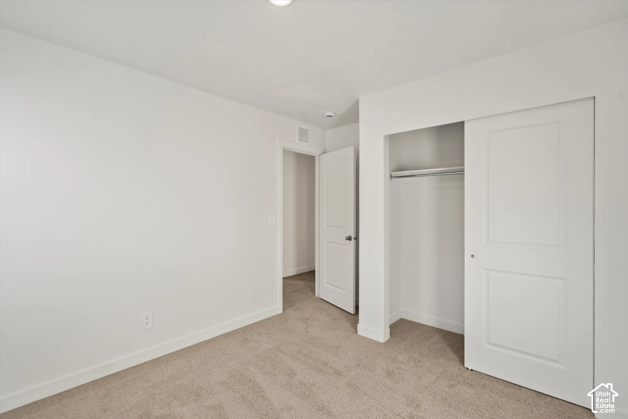 **Disclaimer** Interior package & colors may vary.  Neutral-toned carpeting, white two-panel interior doors, and a reach-in closet featuring a built-in rod