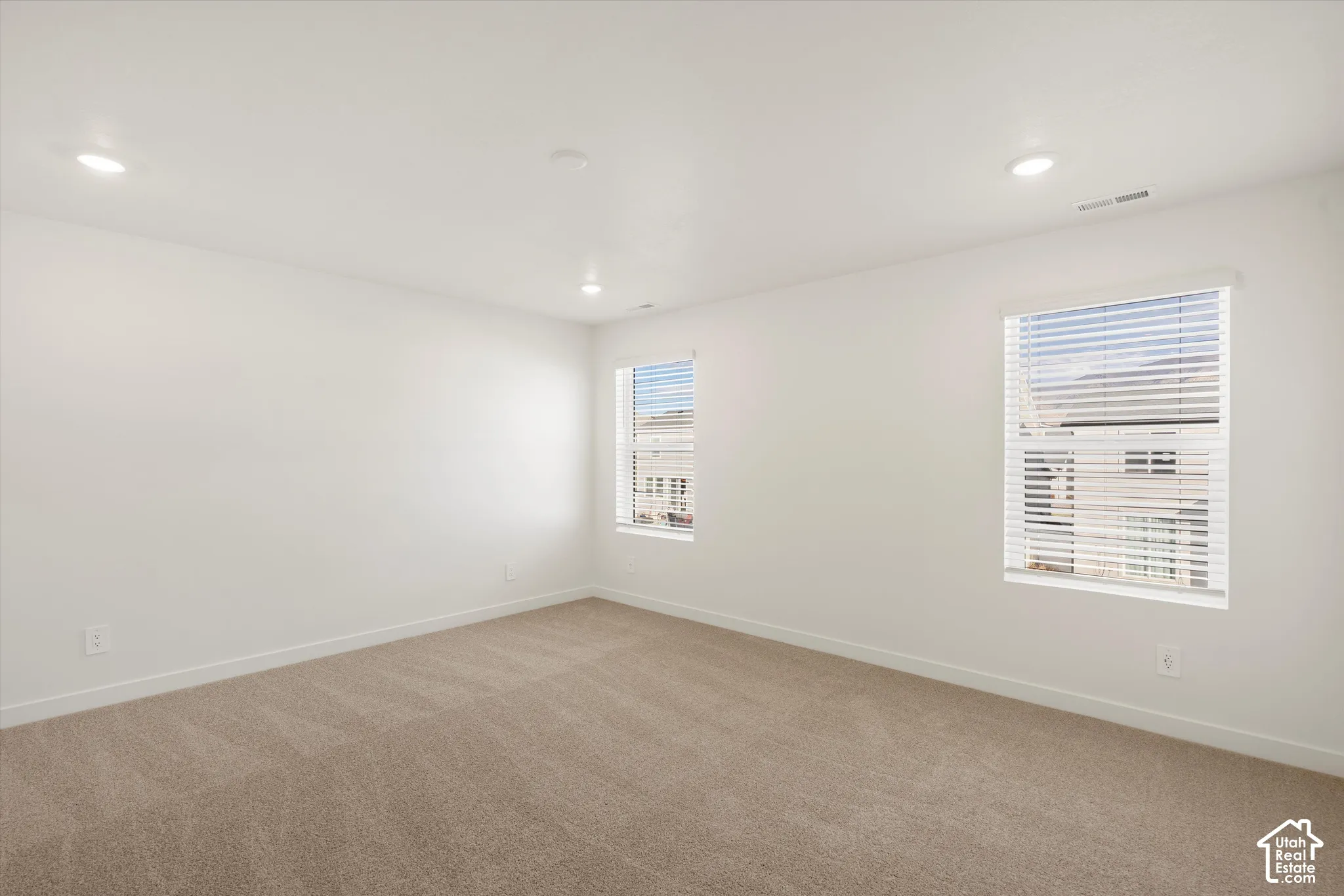 **Disclaimer** Interior package & colors may vary.  Neutral-toned carpeting, recessed ceiling lighting, and windows finished with horizontal blinds
