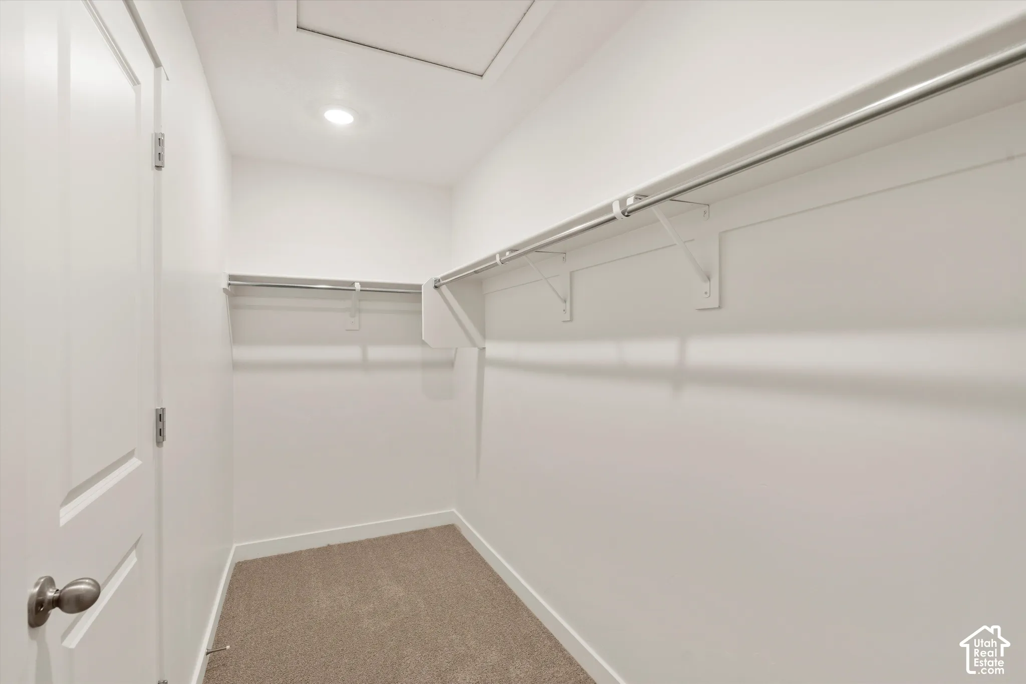 **Disclaimer** Interior package & colors may vary.  Walk-in closet featuring wall-to-wall carpeting, overhead recessed lighting, and multi-level built-in shelving with metal hanging rods