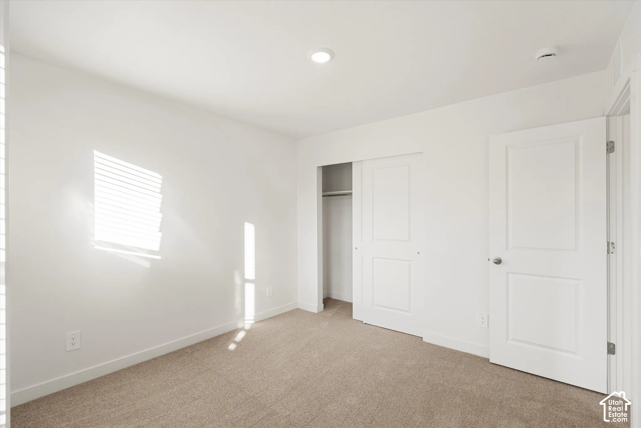 **Disclaimer** Interior package & colors may vary.  Neutral interior featuring wall-to-wall carpeting, recessed ceiling lighting, a sliding closet door, and a paneled interior door