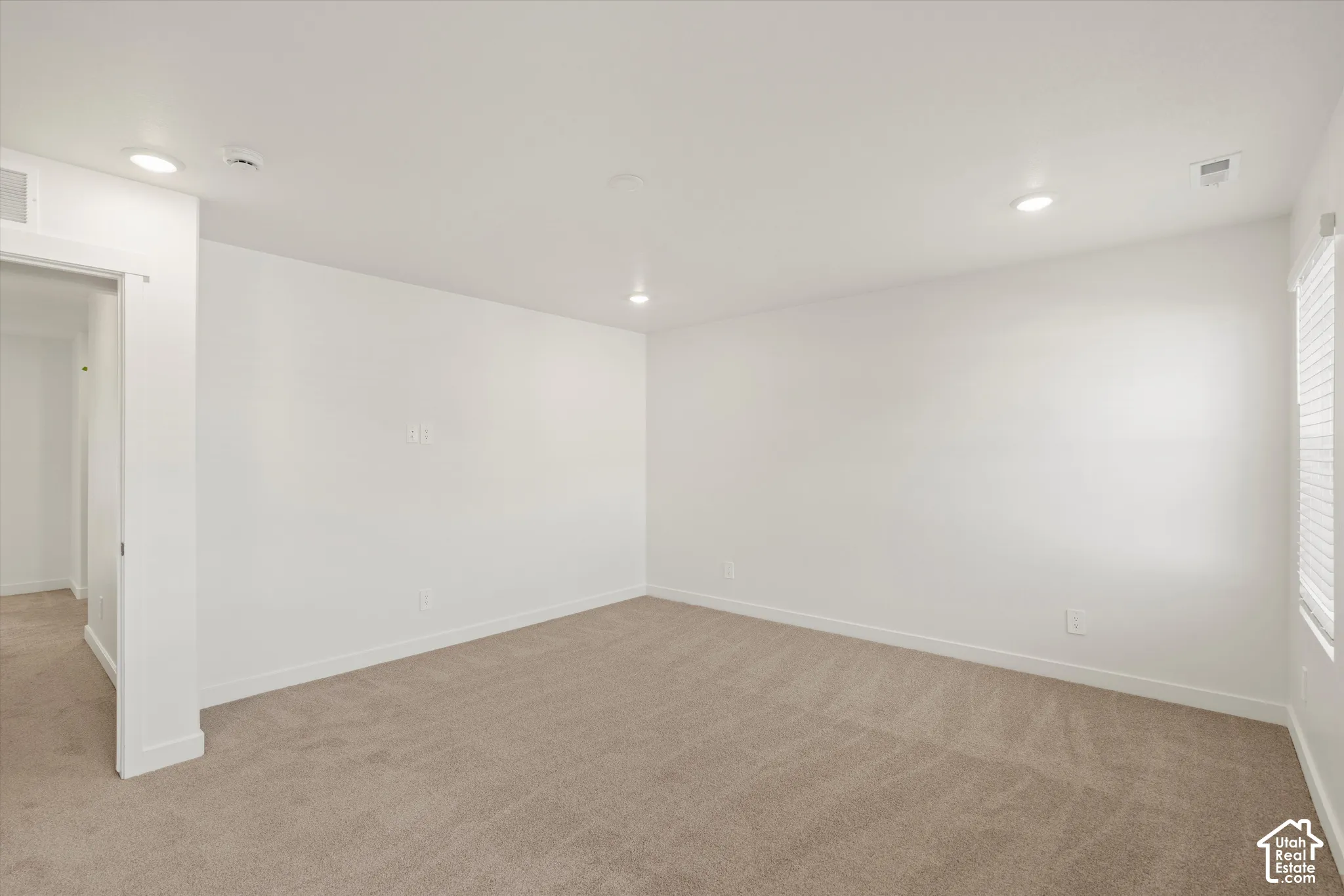 **Disclaimer** Interior package & colors may vary.  Neutral-toned carpeting, recessed ceiling lighting, and a single-window configuration featuring blinds
