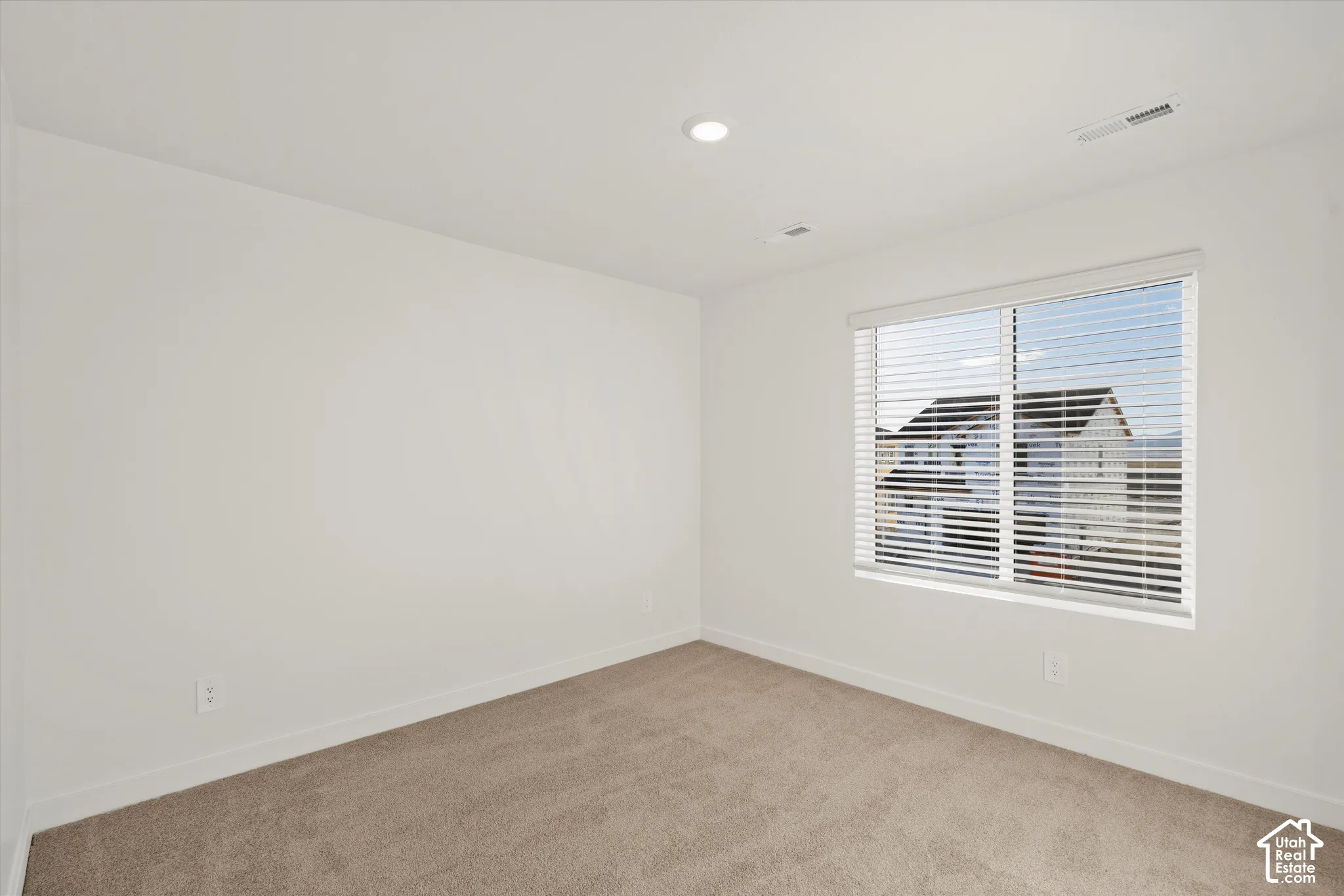 **Disclaimer** Interior package & colors may vary.  Neutral-toned carpeting, recessed ceiling lighting, and a window fitted with horizontal blinds