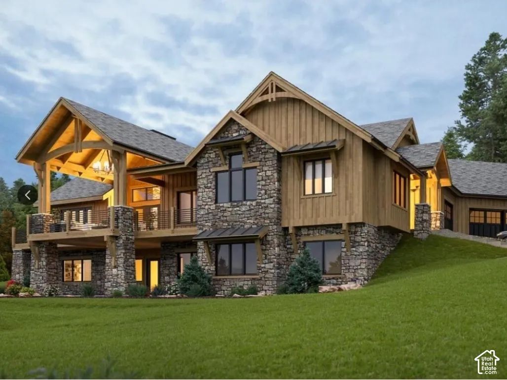 Custom residence featuring stone masonry cladding, vertical wood siding, covered elevated deck with timber framing, gabled rooflines, and a multi-car garage
