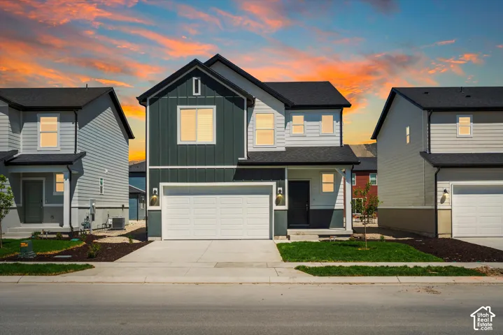 **DISCLAIMER** Elevation and exterior color may vary.  Two-story residence featuring vertical and horizontal siding, a multi-gabled roofline, an attached two-car garage, and a covered entryway