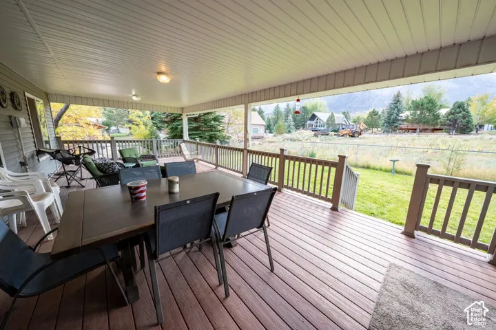 Covered outdoor deck with composite decking, perimeter railing, and recessed ceiling lighting
