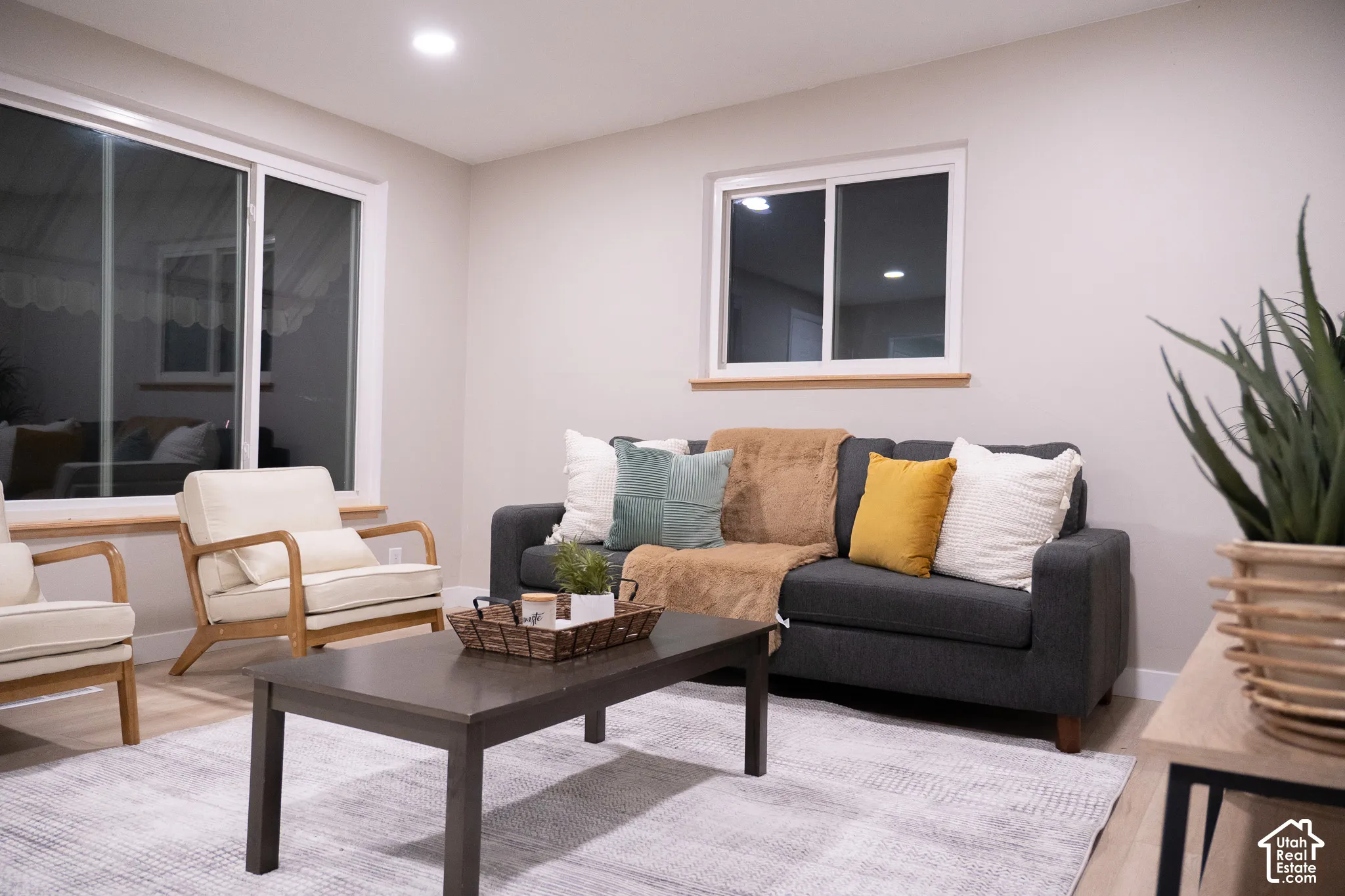Living area featuring neutral wall paint, recessed lighting, wood-finish flooring, sliding glass door, and a horizontal sliding window with a natural wood sill