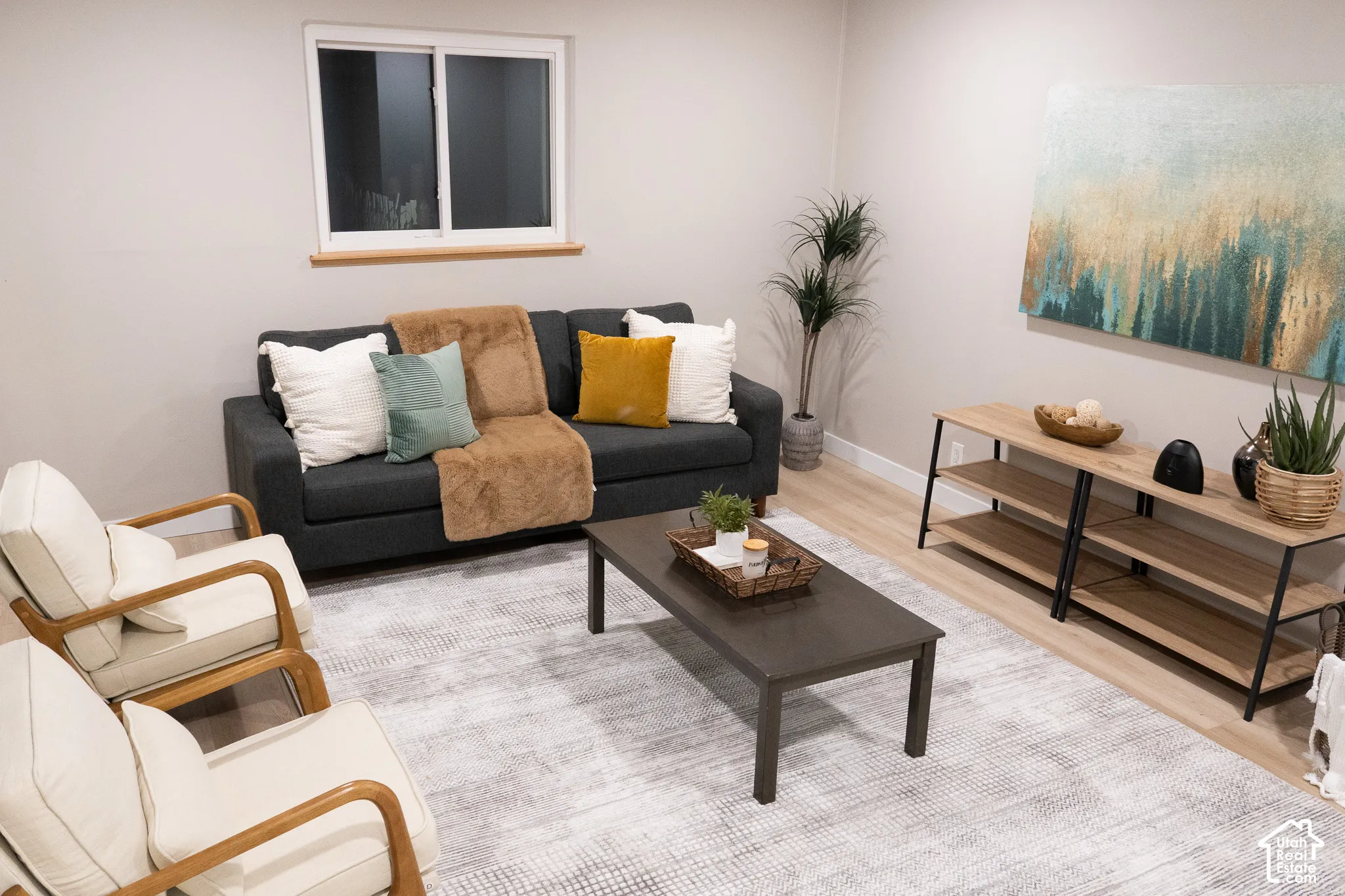 Neutral walls, wood-finish flooring, and a sliding window with a wooden sill