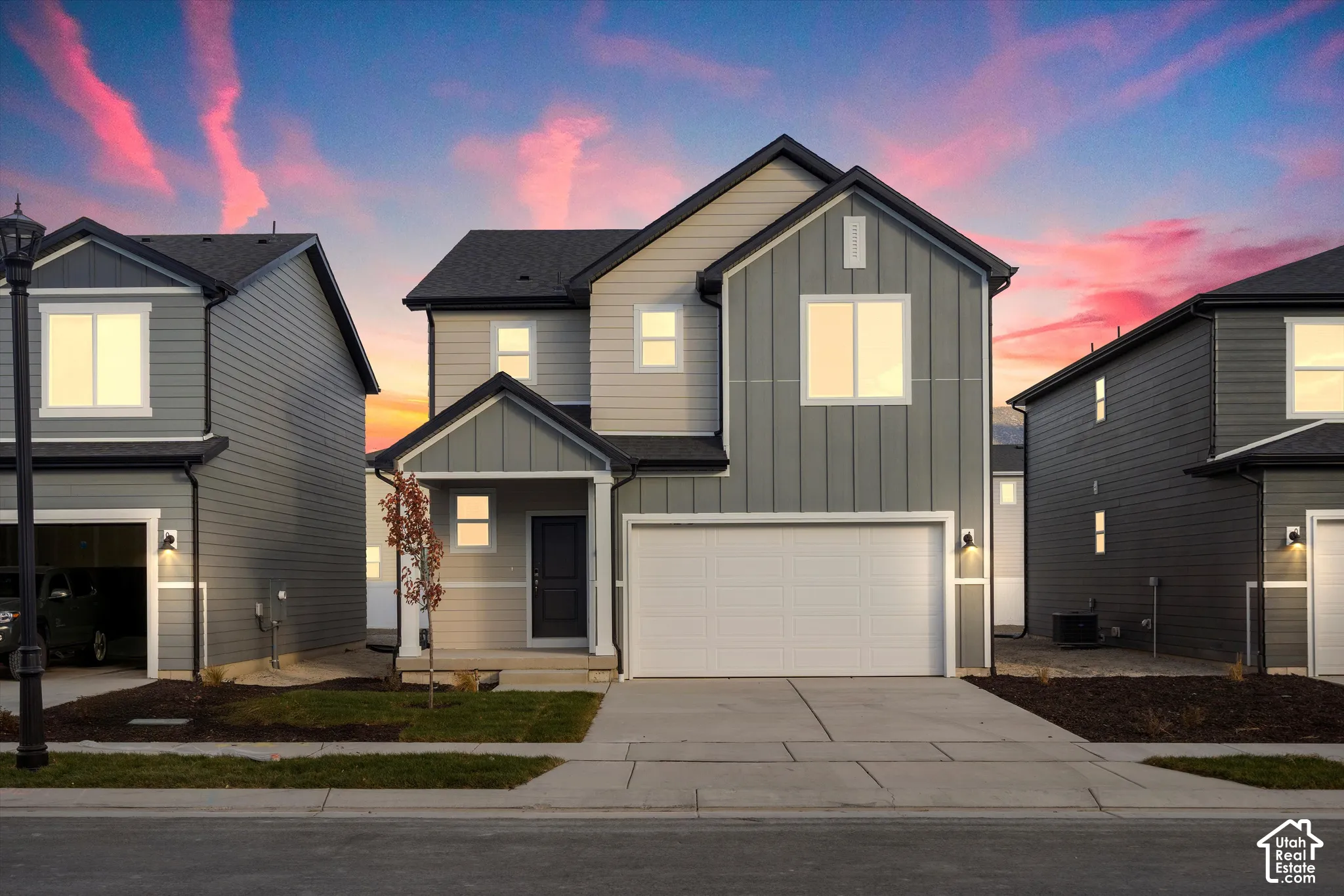 **DISCLAIMER** Elevation and exterior color may vary. Two-story exterior featuring a mix of horizontal lap and vertical board-and-batten siding, a covered front entryway, and an attached two-car garage