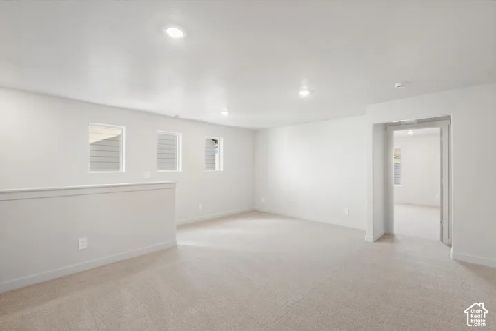 **DISCLAIMER** Interior package may vary. Open interior space featuring neutral wall-to-wall carpeting, recessed ceiling lighting, and three wall-mounted windows