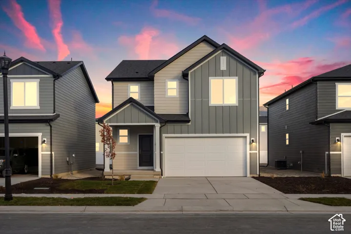 **DISCLAIMER** Elevation and exterior color may vary. Two-story exterior featuring a mix of horizontal lap and vertical board-and-batten siding, a covered front entryway, and an attached two-car garage