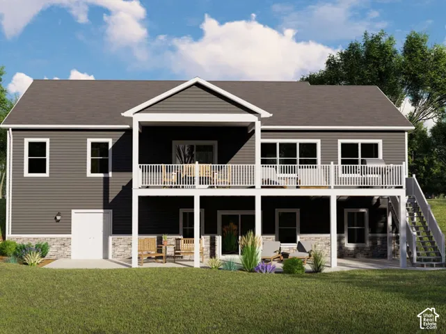 Two-story exterior featuring dark horizontal siding, stone veneer foundation accents, an elevated deck with white railing, a covered concrete patio, and exterior stairs