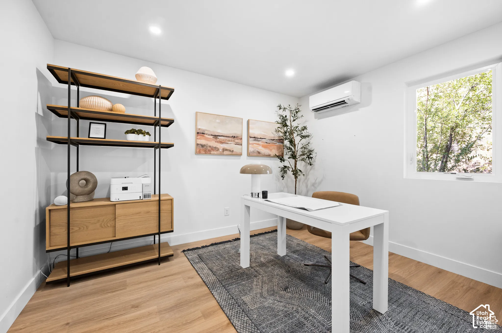 Interior room featuring wood-finish flooring, recessed lighting, and a wall-mounted climate control unit