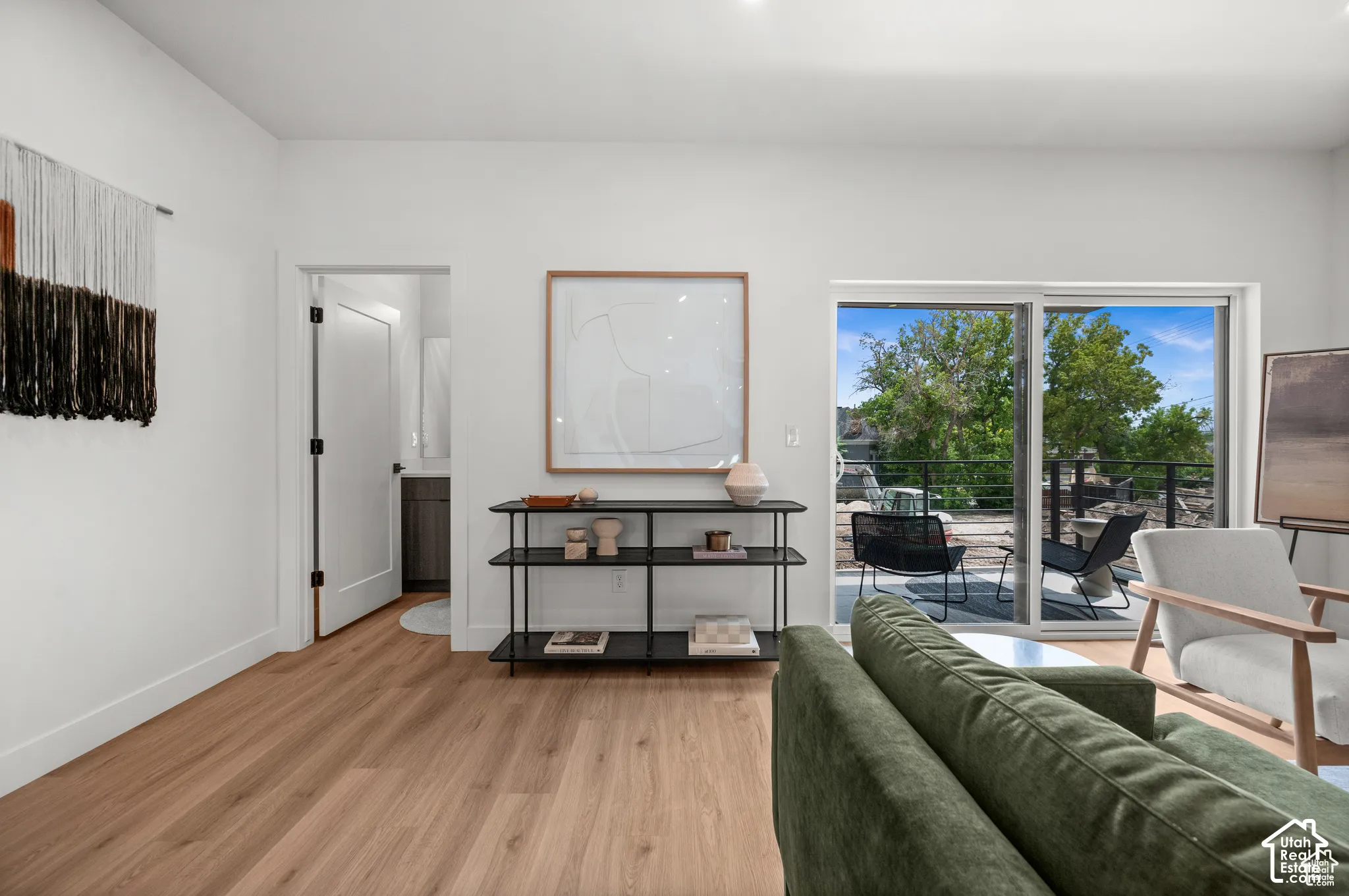 Wood-finish flooring, sliding glass patio door, and recessed ceiling lighting