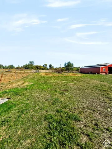 Pasture with red barn and horse walker.