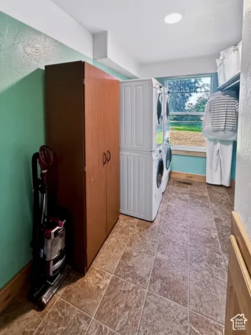 The laundry room is equipped with two sets of washers and dryers and features a central laundry chute.