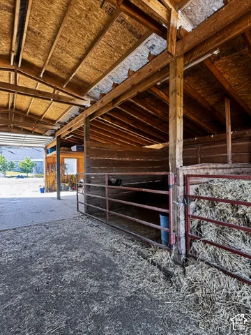Barn interior with horse stalls.