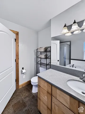 Ensuite bathroom includes a large vanity and laundry chute.
