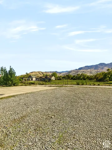 A gravel lane opens up to the main driveway and 3-car garage.