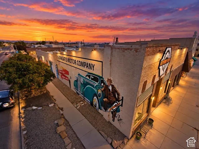 Brick masonry commercial building featuring a prominent exterior wall mural and street-level storefront windows