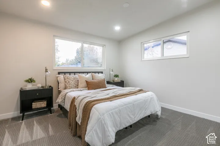 Room featuring neutral wall paint, gray textured carpeting, and recessed lighting with two slider-style windows