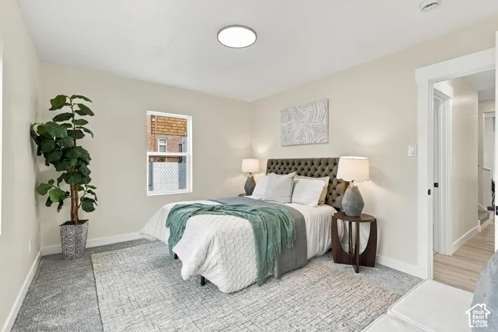 Neutral wall tones, wall-to-wall carpeting, single-hung window, and white interior door trim