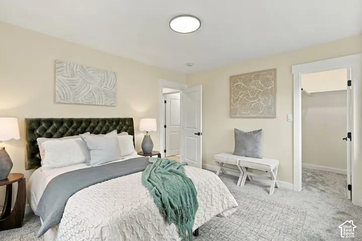 Neutral wall palette, wall-to-wall carpeting, flush-mount lighting, and reach-in closet with built-in shelving