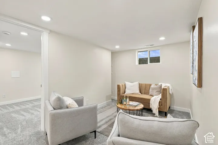 Neutral-toned interior featuring recessed lighting, plush wall-to-wall carpeting, and a rectangular window