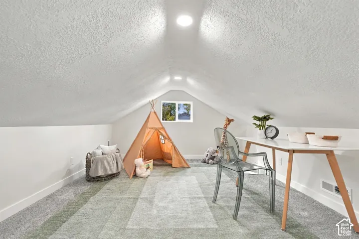 Loft space featuring recessed lighting and wall-to-wall carpeting with a single window
