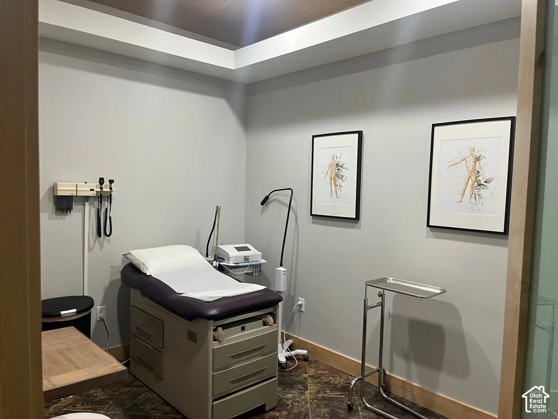 Tray ceiling with recessed lighting and stone-finish flooring