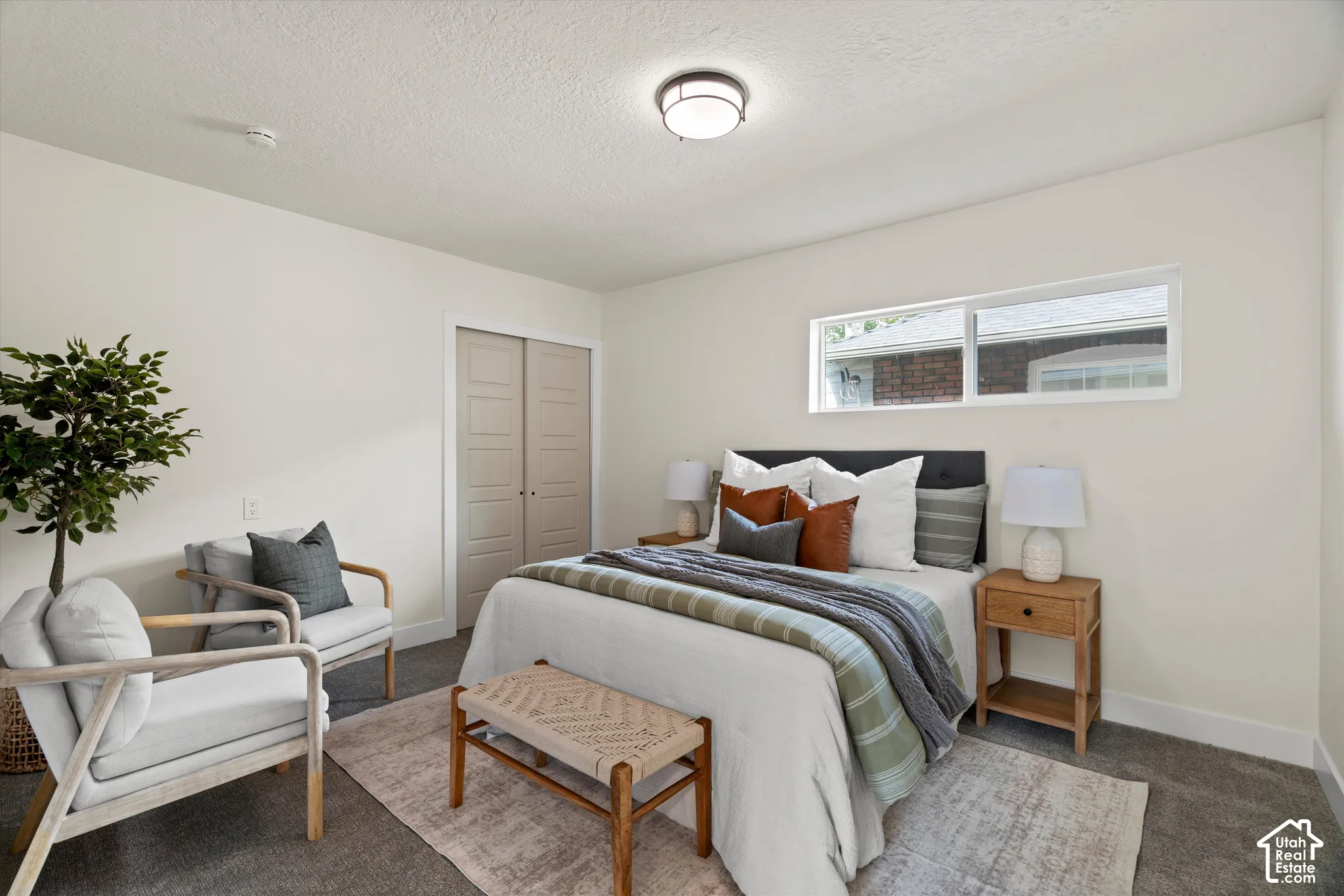 Room featuring wall-to-wall carpeting, horizontal sliding window, and neutral interior paint finishes
