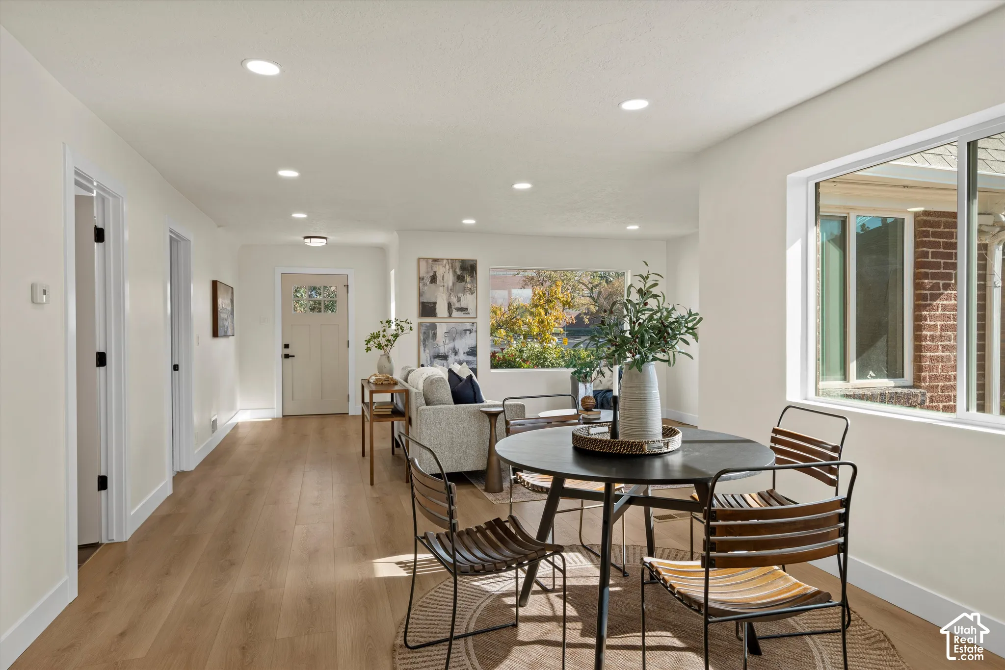 Open interior featuring wood-finish flooring, recessed lighting, and large picture windows