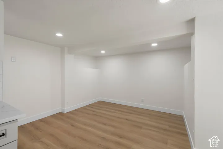 Interior space featuring wood-finish flooring, recessed lighting, and neutral wall paint