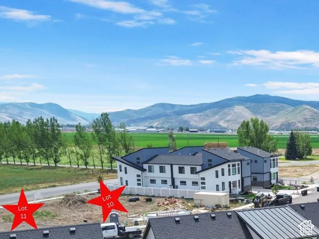 Residential land parcels marked Lot 10 and Lot 11, featuring open topography and mountain scenery