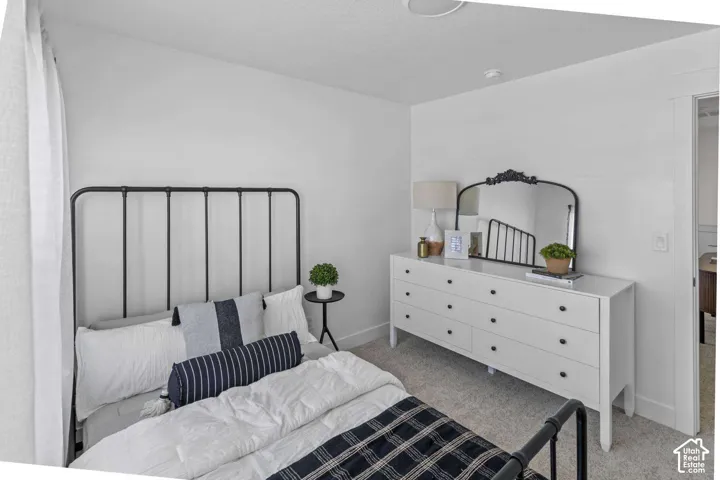 Neutral-toned wall paint, wall-to-wall carpeting, and doorways featuring traditional white trim