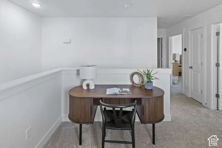 Neutral wall-to-wall carpeting, recessed ceiling lighting, and solid-core interior doors with metallic hardware