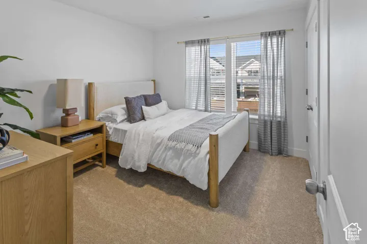 Neutral-toned carpeted flooring, dual-pane windows, and white interior doors with brushed nickel hardware