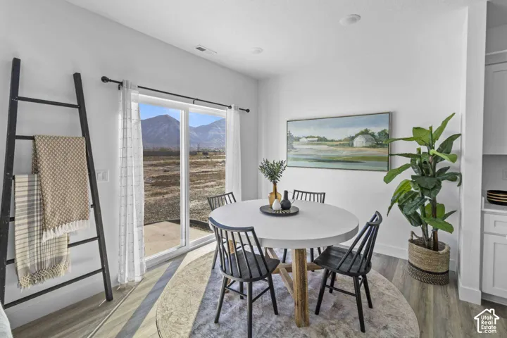 Sliding glass door opening to mountain scenery and recessed lighting
