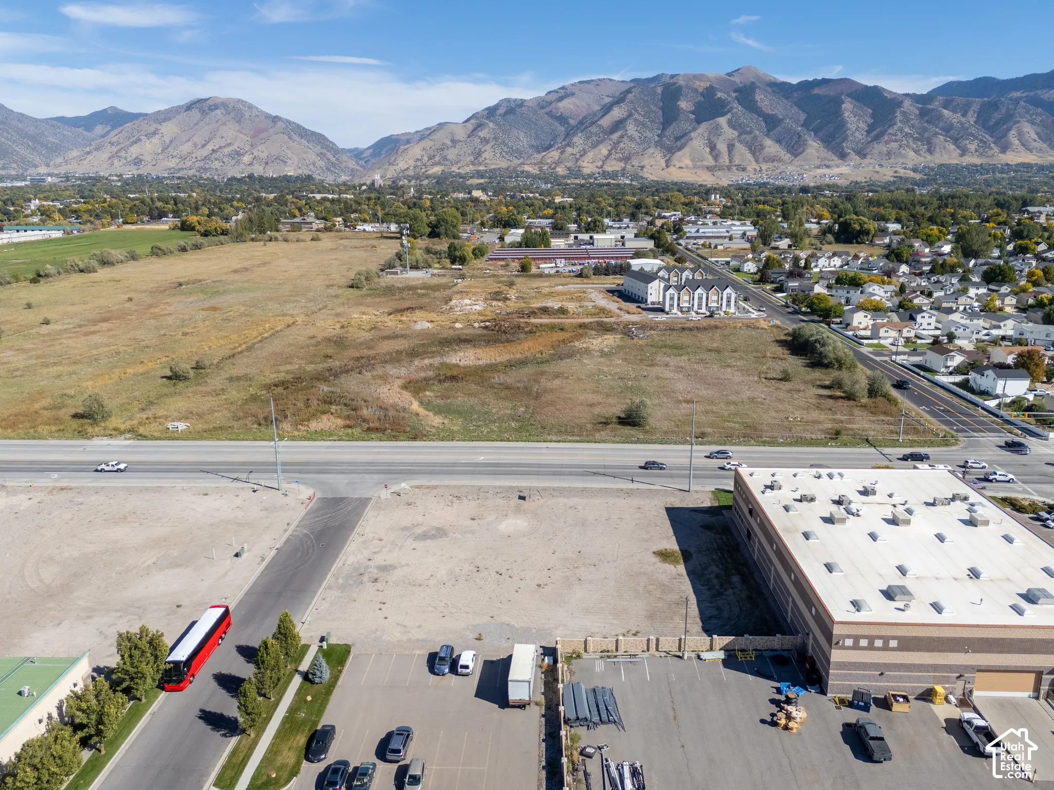 Expansive vacant land parcel featuring paved street access and a prominent mountain range backdrop