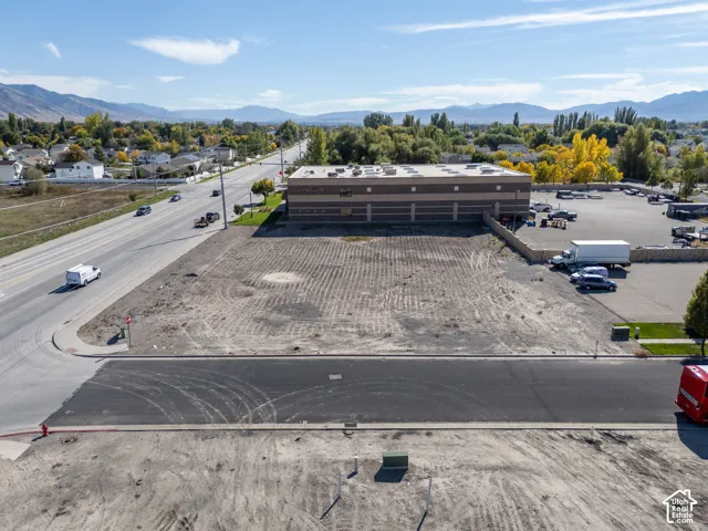 Expansive corner lot with paved street access, mountain backdrop, and proximity to major thoroughfares