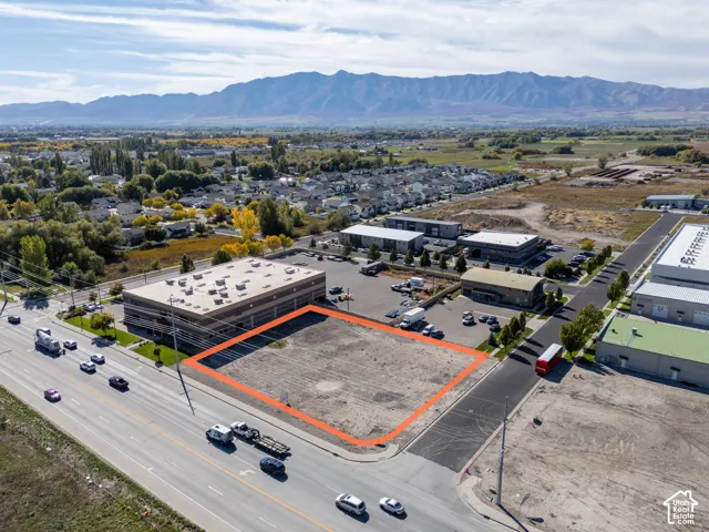 Cleared commercial land parcel featuring street frontage and mountain scenery