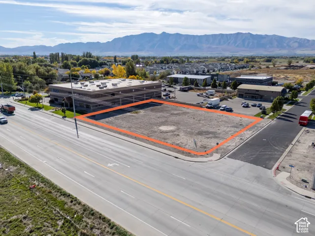 Corner lot featuring primary road frontage, paved street access, and mountain backdrop