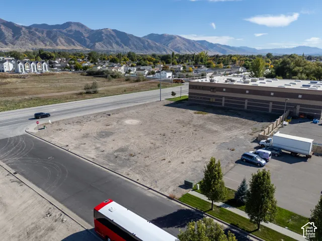 Vacant corner lot featuring paved road access and mountain backdrops