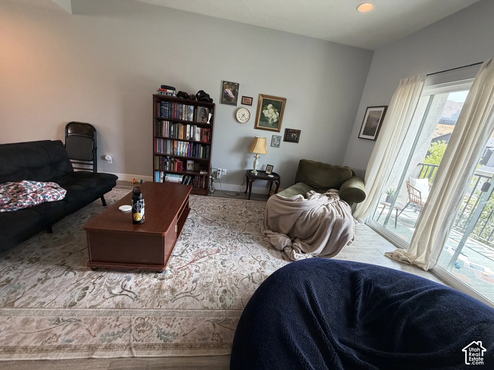Living area featuring high ceilings, recessed lighting, and large sliding glass doors providing outdoor access