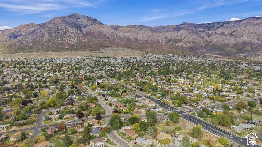 Aerial perspective of a neighborhood setting featuring an expansive mountain backdrop