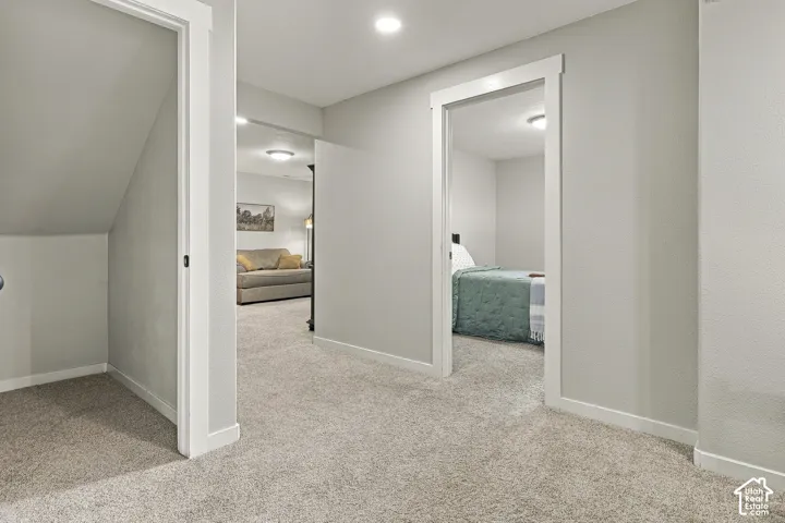 Neutral-toned interior featuring wall-to-wall carpeting, recessed ceiling lighting, and crisp white door trim