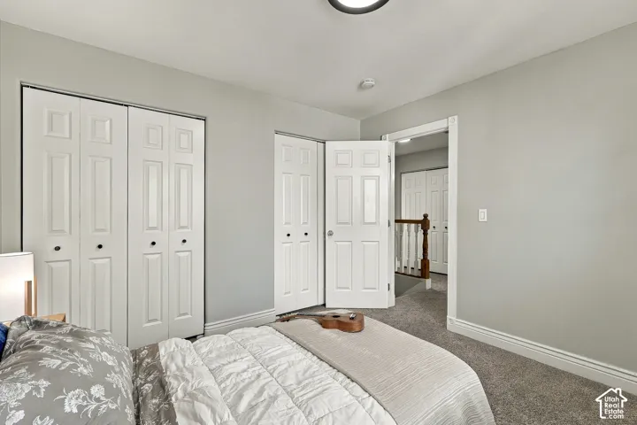 Room featuring neutral wall tones, wall-to-wall carpeting, and double-panel closet doors