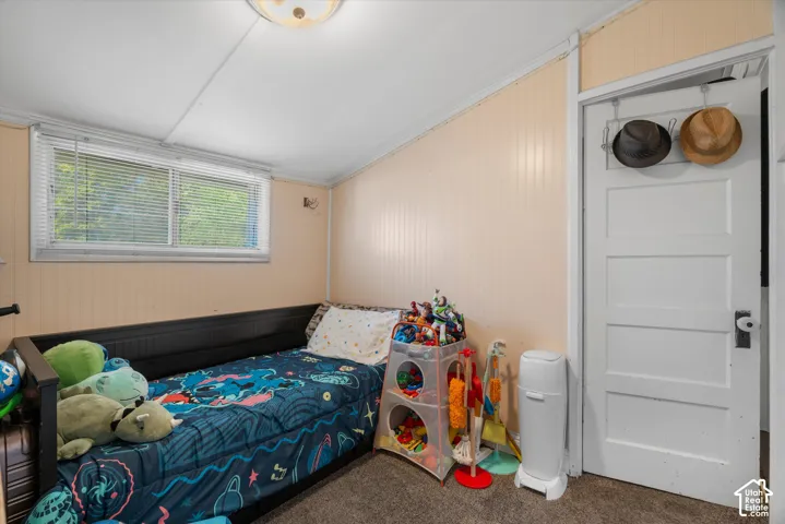 Beadboard wall paneling, multi-panel interior door with vintage-style hardware, horizontal sliding window with blinds, and flush-mount ceiling lighting