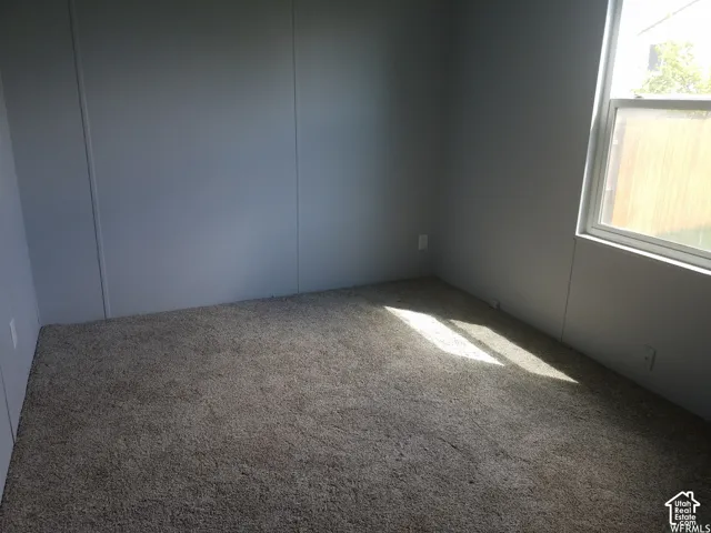 Room featuring neutral wall finishes and wall-to-wall carpeting with an integrated window